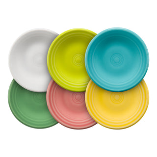 Six round plates in different colors—white, lime green, teal blue, green, pink, and yellow—are arranged in a tight overlapping pattern on a white background.