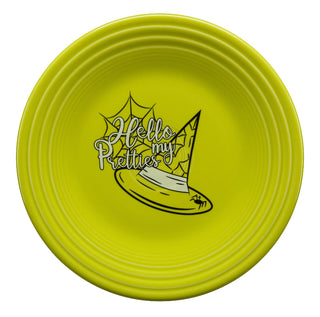 A bright yellow plate featuring a cartoon witch hat, a spiderweb, and the words “Hello my Pretties” in playful lettering at the center.