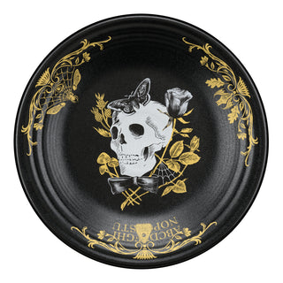 A black plate with gold floral designs, featuring a white skull with a butterfly on top and a rose beside it, plus ornate gold text and patterns around the rim.