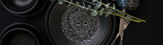 Skull and Vine Shot Glasses with a black background and roses complementing the pattern.