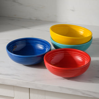 A bright assortment of bowls stacked on a shelf