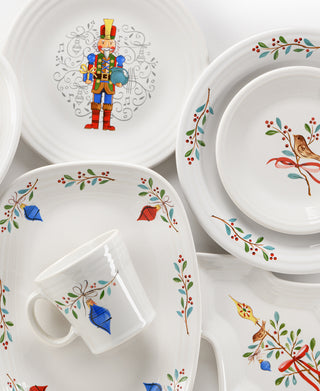 The retired Fiesta Holly Berry Christmas 15 OZ Tapered Mug features lead-safe white china with festive hand-painted style holly, birds, and ornaments designs in red, green, blue, and gold.