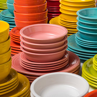 Fiesta's Retired Classic Rim 12-Piece Dinnerware Set, Service for 4, features a vibrant mix of dishwasher-safe, lead-safe ceramic plates and bowls in red, orange, yellow, green, teal, pink, and white—perfectly organized for a bold display.
