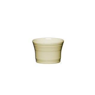 The Fiesta Retired Dip Bowl is a small, light yellow ceramic bowl with a glossy finish and subtle ridges, crafted from lead-safe china. Centered on a white background, it adds classic Fiesta style to your table.