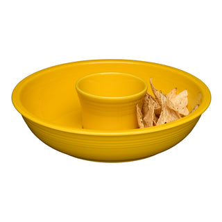 The Fiesta Retired 2-Piece Chip and Dip Set in Daffodil, made from lead-safe, microwave-safe china, holds tortilla chips in its large outer section with a raised center compartment, all displayed on a white background.