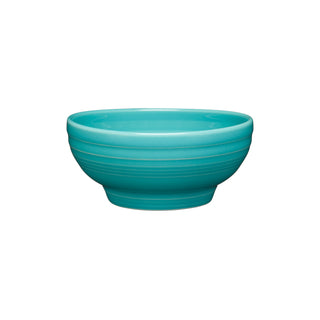 The Fiesta Retired Small 5 1/8 Inch Footed Bowl (14 oz) in turquoise, made in the USA, features a smooth glossy finish with horizontal ridges and is shown against a white background.