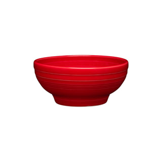The Fiesta Retired Small 5 1/8 Inch Footed Bowl (14 OZ) in scarlet features subtle horizontal grooves and a wide rim. Made in the USA, it is crafted from ceramic and is shown on a white background.