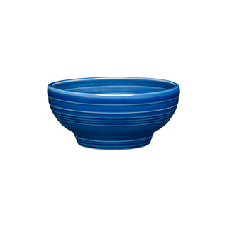The Fiesta Retired Small 5 1/8 Inch Footed Bowl (14 OZ) in lapis is a round, ceramic bowl with horizontal ridges, made in the USA, shown on a white background.