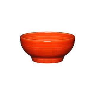 The Fiesta Retired Small 5 1/8 Inch Footed Bowl in poppy color features a glossy vitrified china finish and subtle horizontal exterior lines, shown against a plain white background. Holds 14 oz.