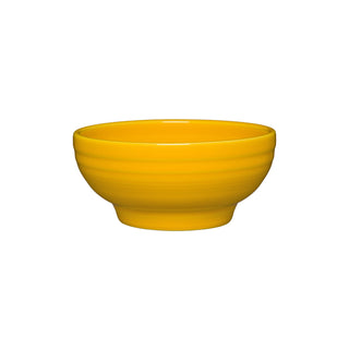 The Fiesta Retired Small 5 1/8 Inch Footed Bowl (14 oz) in daffodil features subtle horizontal ridges, a glossy vitrified china finish, and is made in the USA. Shown on a plain white background.
