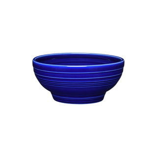The Fiesta Retired Small 5 1/8 Inch Footed Bowl in twilight is a round, vitrified china bowl with raised lines near the rim and base, made in the USA and shown on a white background. Capacity: 14 oz.