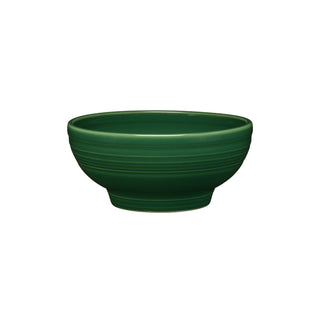 The Fiesta Retired Small 5 1/8 Inch Footed Bowl (14 OZ) in jade features a smooth, matte finish and subtle horizontal ridges. Made in the USA, it's shown on a white background.