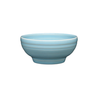The Fiesta Retired Small 5 1/8 Inch Footed Bowl (14 OZ) in sky features a slightly flared rim and subtle horizontal ridges, crafted in the USA and displayed on a white background.