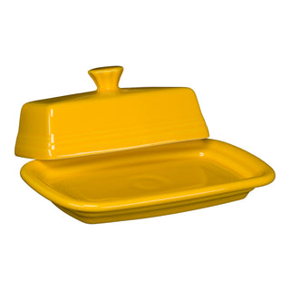 The Fiesta Retired Extra Large Covered Butter Dish in Daffodil measures 8 1/8" x 5 1/8", features a rectangular base with a knob handle lid, and is made in the USA from lead-safe china. Shown against a white background.