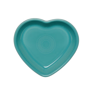 A Fiesta Retired 7.5" Medium Heart Shaped Bowl, 17 oz, in turquoise ceramic with concentric center circles, made in the USA, is displayed on a white background.