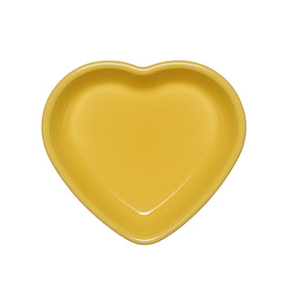The photo shows a sunflower-colored Fiesta Retired 7 1/2 Inch Medium Heart Shaped Bowl (17 OZ), made in the USA, viewed from above on a white background.