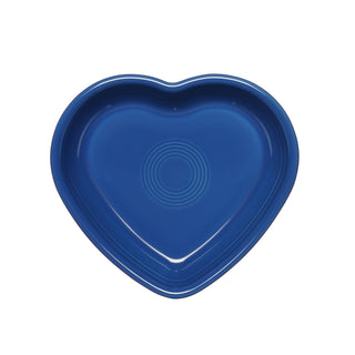 A lapis blue Fiesta Retired 7 1/2 Inch Medium Heart Shaped Bowl (17 oz) with concentric circular ridges, made in the USA from lead-safe china, shown from above on a white background.