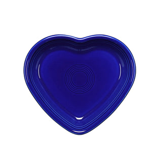 A twilight blue Fiesta 7 1/2-inch medium heart-shaped ceramic bowl (17 oz), viewed from above on a white background; features concentric circular patterns and is made in the USA.