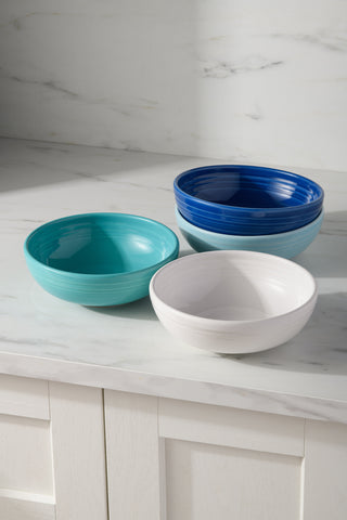 The Fiesta Mixed Coastal Blue Bistro Coupe 7 5/8-Inch 38OZ Medium Bowls, Set of 4, features four vibrant lead-free ceramic bowls in coastal shades—perfect for adding color and style to your kitchen.