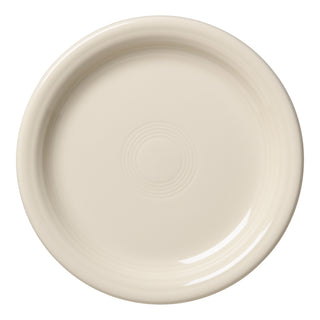 The Fiesta Retired Linen Bistro Coupe 6 1/4 Inch Appetizer Plate features a plain, round, off-white design with a slightly raised edge—an elegant, versatile plate for your dinnerware collection or an ideal classic appetizer plate.
