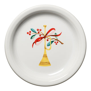 The Fiesta Retired Holly Berry Christmas Bistro Coupe 6 1/4 Inch Appetizer Plate features a festive golden trumpet with red ribbon, green leaves, and berries at the center; this lead-safe ceramic china is made in the USA.