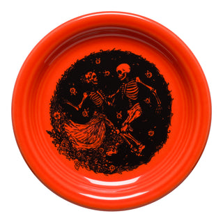 The Fiesta Retired Skeleton Duet Poppy Bistro Coupe 6 1/4 Inch Appetizer Plate features two black dancing skeletons amid flowers on bright orange vitrified china. Dishwasher safe and made in the USA.