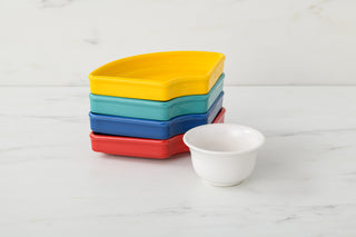 The Fiesta Vibrant 5-Piece Mixed Colors Entertaining Set, featuring a small white bowl and four square dishes in yellow, teal, blue, and red (8 1/5 inch), is perfect for serving snacks on your charcuterie tray.