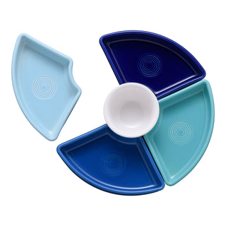 The Fiesta Coastal Blues 5-Piece Mixed Colors Entertaining Set features four blue-hued trays forming a circle around a white bowl, creating an elegant 8 1/5-inch charcuterie set ideal for entertaining.