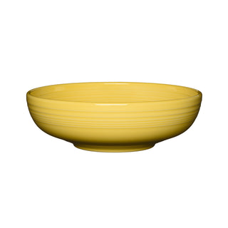 The Fiesta Retired Bistro Coupe 10 1/2 Inch Extra Large Bowl, 96 oz, in sunflower features smooth ceramic with subtle horizontal ridges and a glossy finish. Made in the USA, it's shown against a white background.