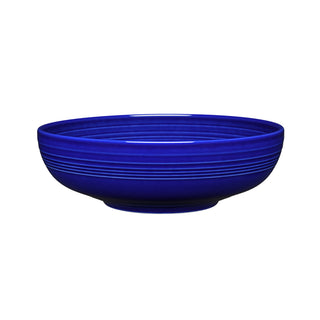 A deep, round Fiesta Retired Bistro Coupe 10 1/2 Inch Extra Large Bowl (96 OZ) in twilight, featuring horizontal rim ridges and set against a white background. Ideal as a serving bowl and proudly made in the USA.