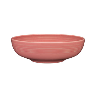 The Fiesta Retired Bistro Coupe Extra Large Bowl, 10 1/2 inch, in Peony features a shallow, round pink ceramic design with a smooth matte finish and subtle horizontal ridges near the rim. Shown on a white background. Capacity: 96 OZ.