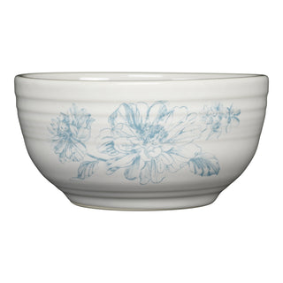 The Fiesta Botanical Floral Sky Bistro Coupe 5 1/2 Inch Cereal Bowl (22 oz) is a white, dishwasher safe ceramic bowl featuring subtle ridges and a light blue floral design with large flowers and leaves.