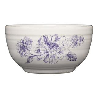 The Fiesta Botanical Floral Lavender Bistro Coupe 5 1/2 Inch Cereal Bowl, 22 oz, is a white ceramic bowl with a blue blossom and leaf design, ridged rim texture, and is dishwasher safe for easy cleaning.