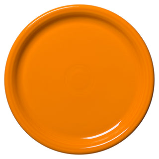 The Fiesta Retired Bistro Coupe 10 1/2 Inch Dinner Plate is a round, bright orange ceramic plate with a glossy finish and subtle concentric circles in the center, made in the USA and shown on a white background.