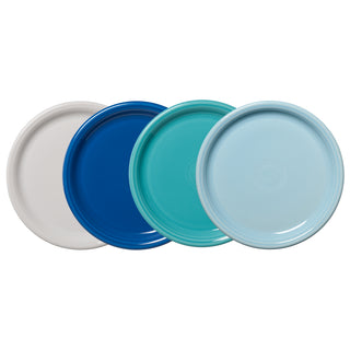 The Fiesta Mixed Coastal Blues Bistro Coupe 10 1/2 Inch Dinner Plate Set of 4 features round plates in white, dark blue, teal, and light blue with overlapping edges arranged on a white background.