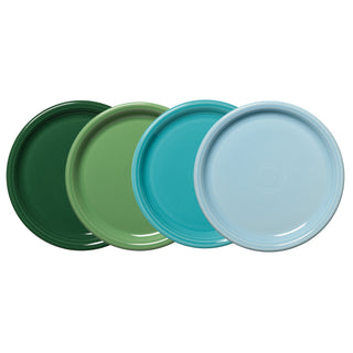 The set of four Fiesta Mixed Aegean Bistro Coupe 10 1/2 Inch Dinner Plates features dark green, light green, turquoise, and light blue plates, stylishly arranged overlapping in a row against a white background.