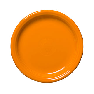 The Fiesta Retired Bistro Coupe 7 1/4 Inch Salad Plate in butterscotch is a round, vibrant dish with a glossy finish and subtle circular center patterns, crafted in the USA from lead-safe china and shown from above on a white background.