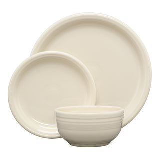 The Fiesta Bistro Coupe 3-Piece Place Setting in Linen includes a dinner plate, salad plate, and bowl with subtle ridged details, all stacked against a plain white background.
