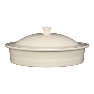 The Fiesta Small 10 Inch Round Covered Casserole, 1.4 Quart in Linen, is a cream-colored ceramic dish with a matching lid and top handle, displayed against a plain white background.