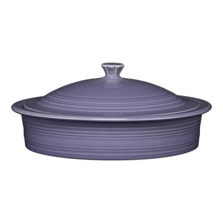 The Fiesta Lavender Small 10 Inch Round Covered Casserole (1.4 Quart) is a purple ceramic dish with ribbed detail, matching lid, and knob handle—oven safe for serving meals hot and stylish at your table.