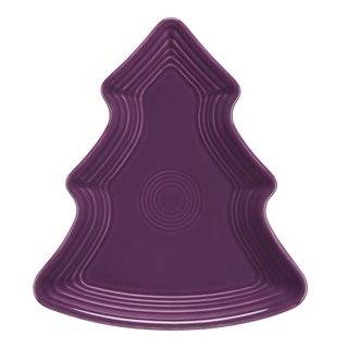 The Retired Fiesta Tree Shaped Plate by Fiesta, in Mulberry, is a 10 1/8-inch lead-safe ceramic plate made in the USA. Its tree shape and glossy finish bring festive charm to any table setting.