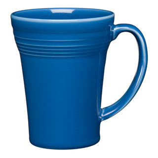 The Fiesta 18 OZ Bistro Latte Mug by Fiesta is shown against a white background. It features a plain blue ceramic body, a large handle, and horizontal ridges near the top. Made in the USA.