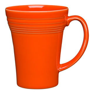 The Fiesta 18 OZ Bistro Latte Mug by Fiesta is a bright orange ceramic mug made in the USA, featuring a large handle, slightly flared rim, and three horizontal grooves near the top, photographed against a white background.
