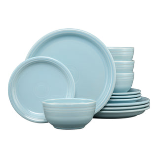 The Fiesta Bistro Coupe 12-Piece Dinnerware Set in sky includes plates and bowls for 4, featuring simple circular designs and a glossy finish, all stacked neatly in an organized arrangement.