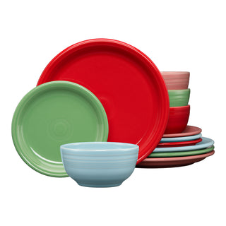 The Fiesta Peppermint Frost Mixed Color Bistro Coupe 12-Piece Dinnerware Set, service for 4, features stylish plates and bowls in red, green, blue, and pink. Dishwasher safe and perfect for everyday use, this colorful set is stacked against a white background.