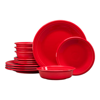 A Fiesta Classic Rim 12-Piece Dinnerware Set in scarlet, featuring plates, bowls, and salad plates for 4, is stacked neatly in groups against a white background.