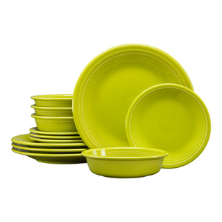 The Fiesta Retired Classic Rim 12-Piece Dinnerware Set in lemongrass features plates and bowls stacked on a white background. This lead-safe, USA-made set is dishwasher safe and serves four.