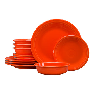 The Fiesta Classic Rim 12-Piece Dinnerware Set, Service for 4, in vibrant poppy color, features plates and bowls stacked neatly against a white background—perfect for adding color and style to your table.
