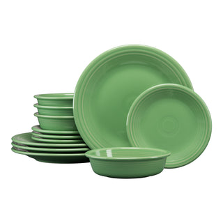 The Fiesta Classic Rim 12-Piece Dinnerware Set in meadow includes dinner plates, salad plates, and bowls for 4. Each piece features a simple, glossy finish with grooved edges.