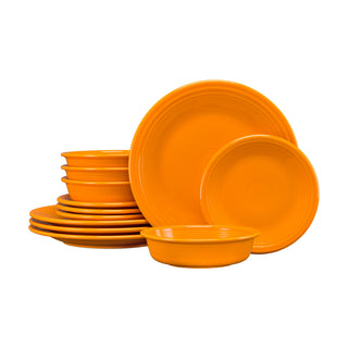 The Fiesta Retired Classic Rim 12-Piece Dinnerware Set in butterscotch, service for 4, features USA-made dishwasher-safe plates, bowls, and saucers stacked against a white background.